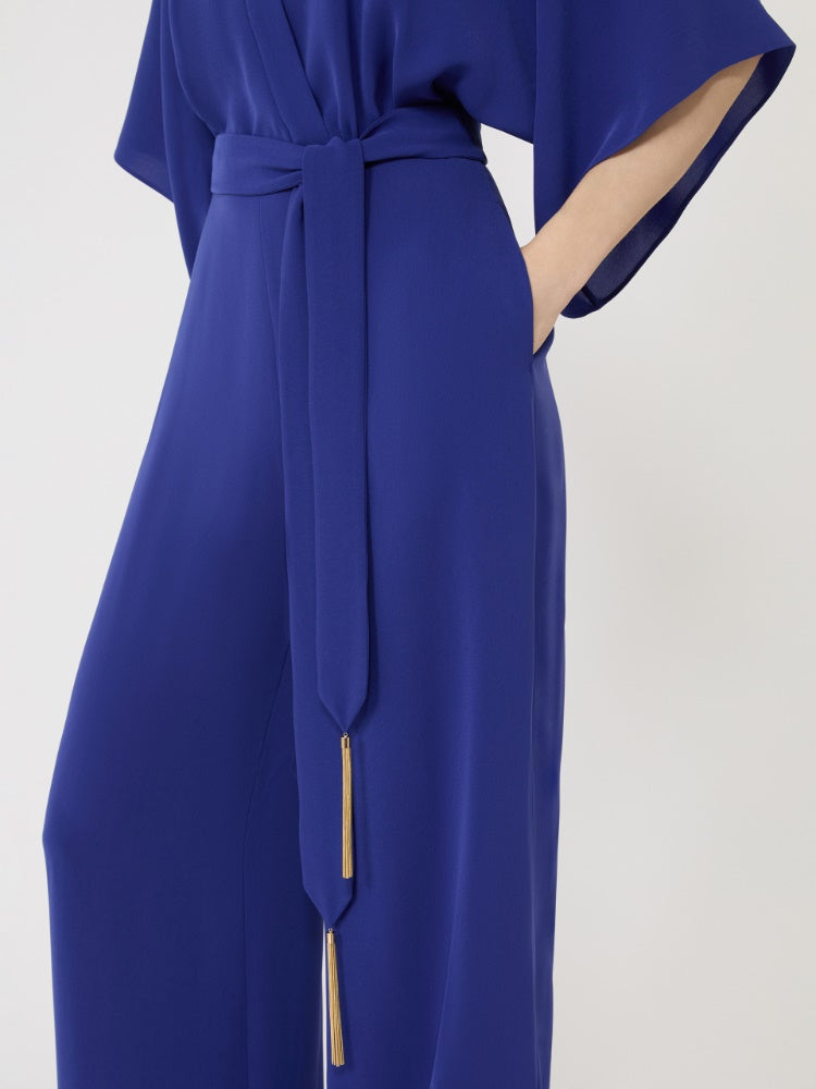 Blue jump suit with a belt on a white background