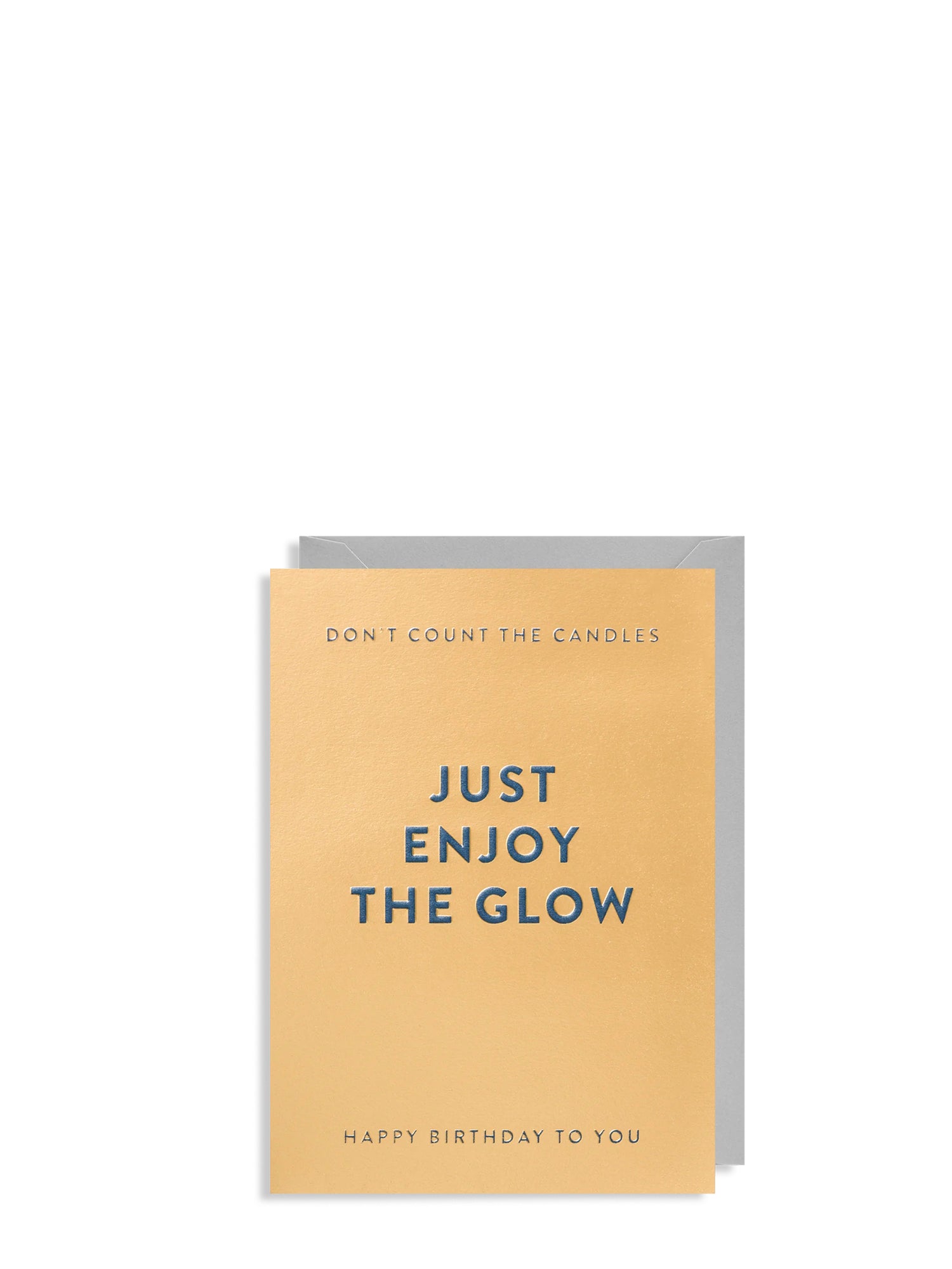 Birthday card with text 'Just enjoy the glow' on a beige background