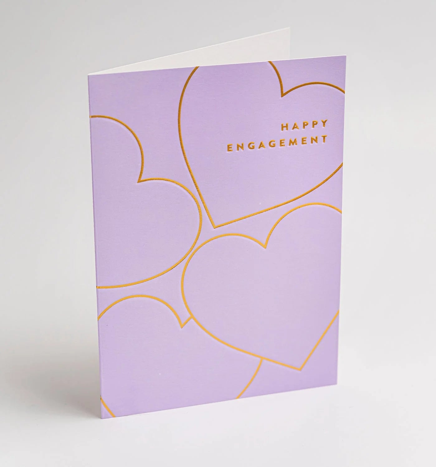 Purple card with gold hearts and 'Happy Engagement' text on a light gray background