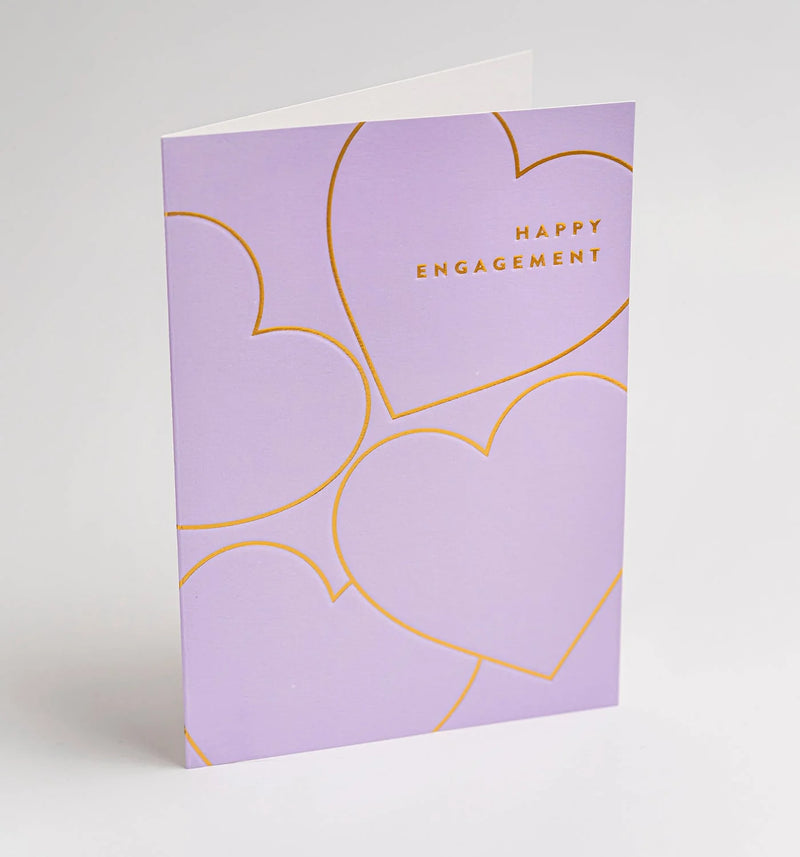 Purple card with gold hearts and 'Happy Engagement' text on a light gray background