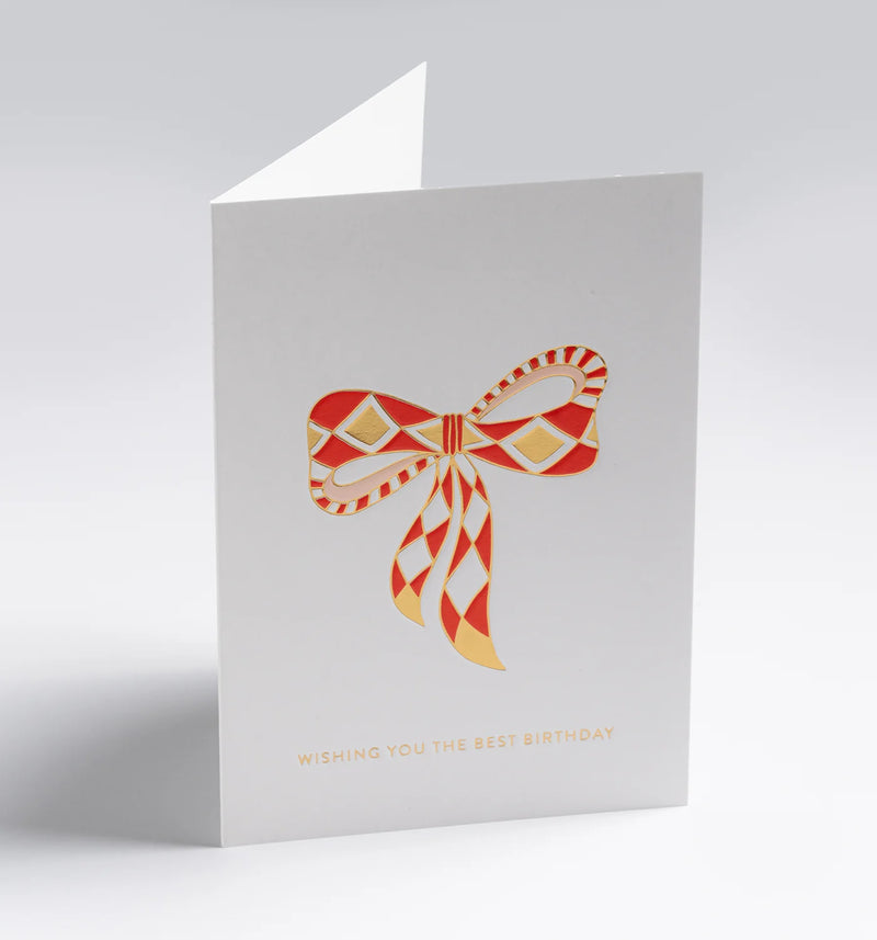 Greeting card with a red and gold bow design on a white background