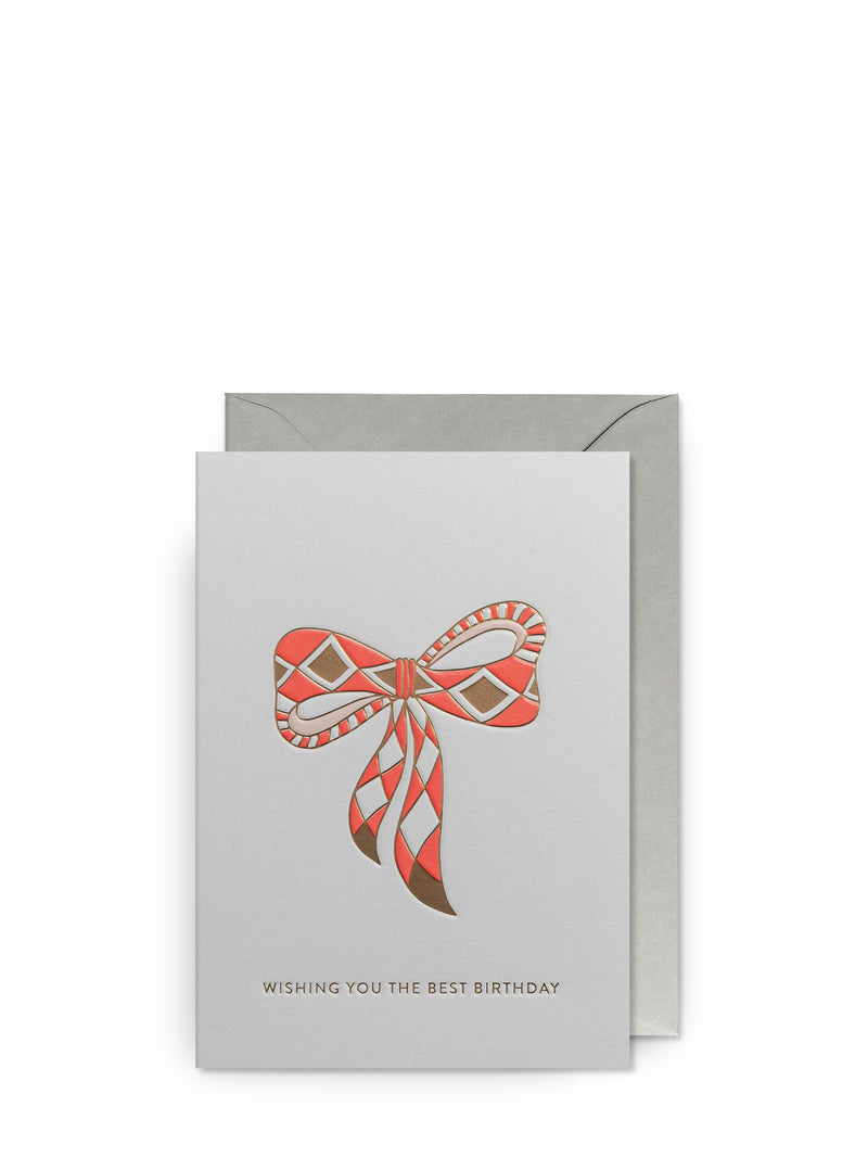 White reeting card with a decorative bow design and golden text WISHING YOU THE BEST BIRTHDAY on a white background