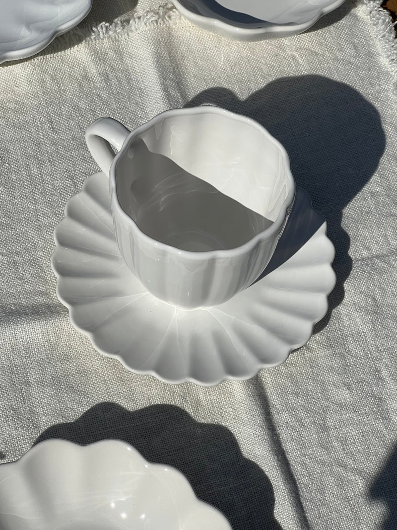 White ceramic gravy boat on a textured surface