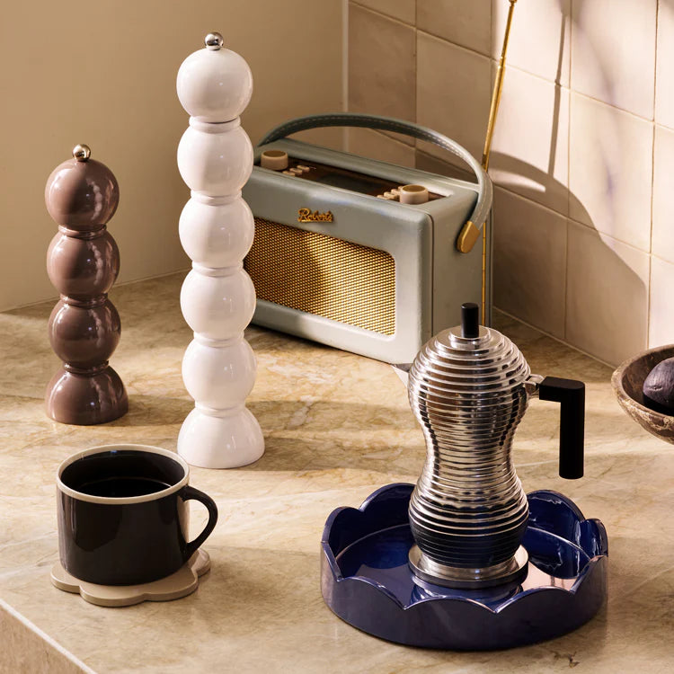 Vintage-style radio, coffee maker, and decorative items on a countertop.