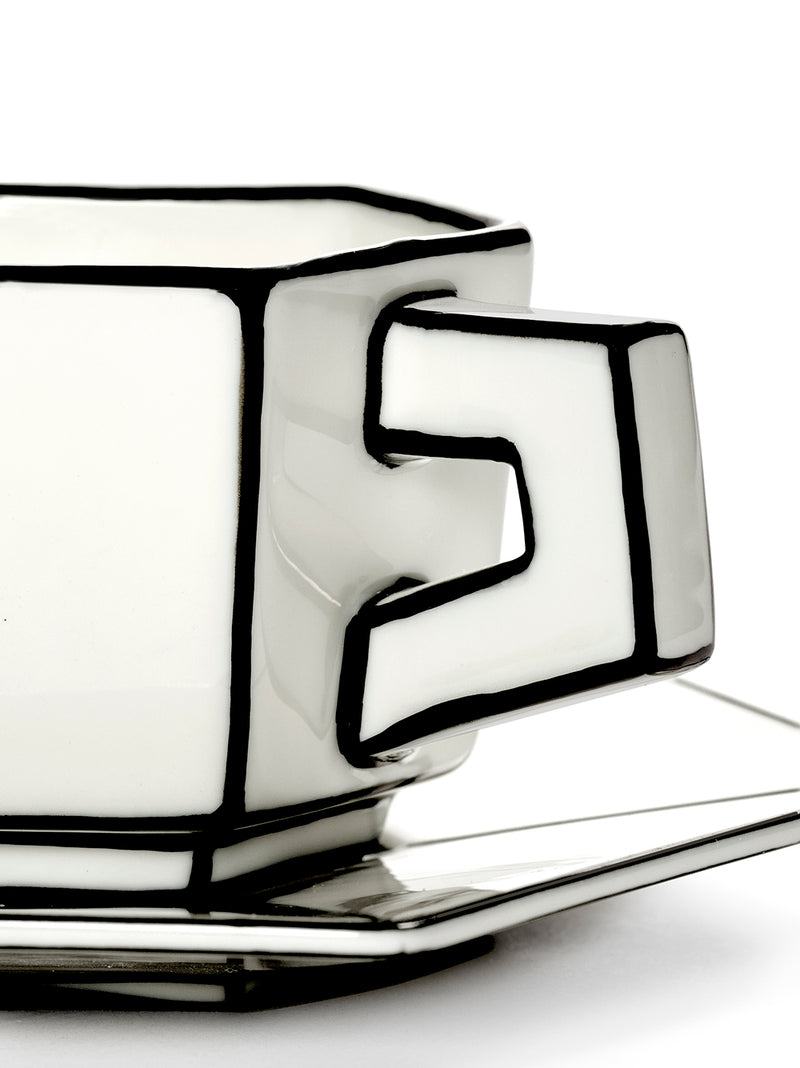 Ceramic espresso mug and saucer with geometric design on a white background
