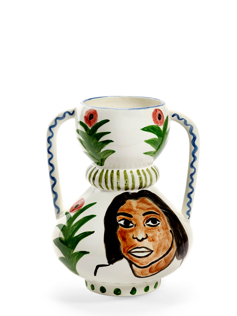 Ceramic vase with a face design and floral elements on a white background