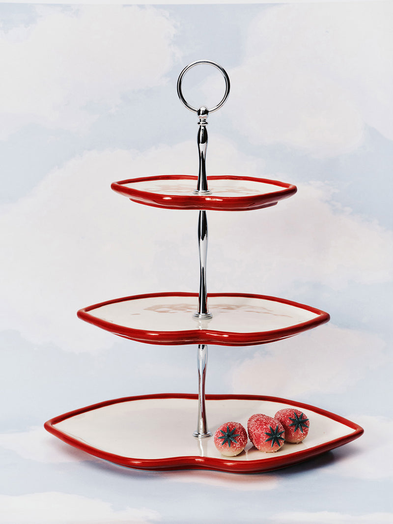 Three-tiered serving tray with red trim on a white background