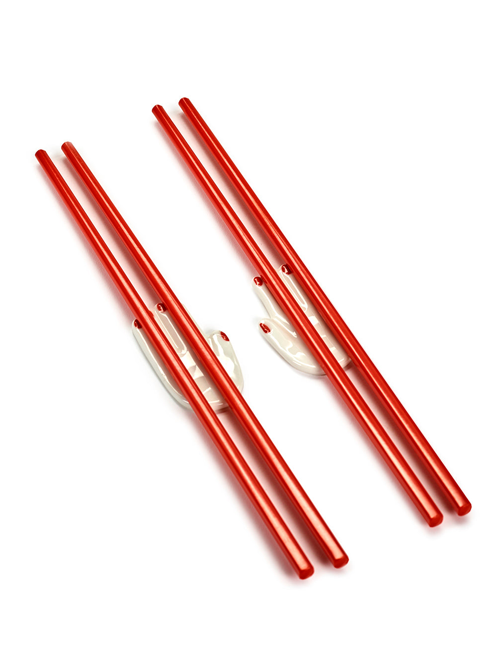 Set of red chop sticks on a white background