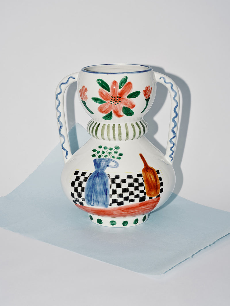 Decorative ceramic vase with floral and abstract designs on a light gray background