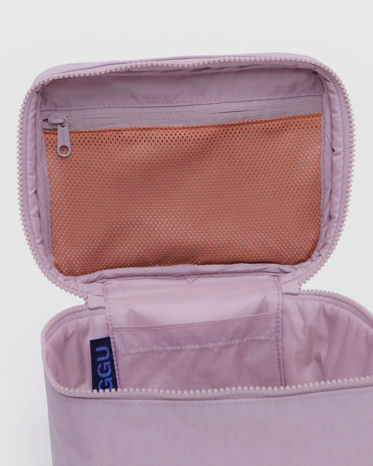 Open purple travel pouch with mesh pocket on a light gray background