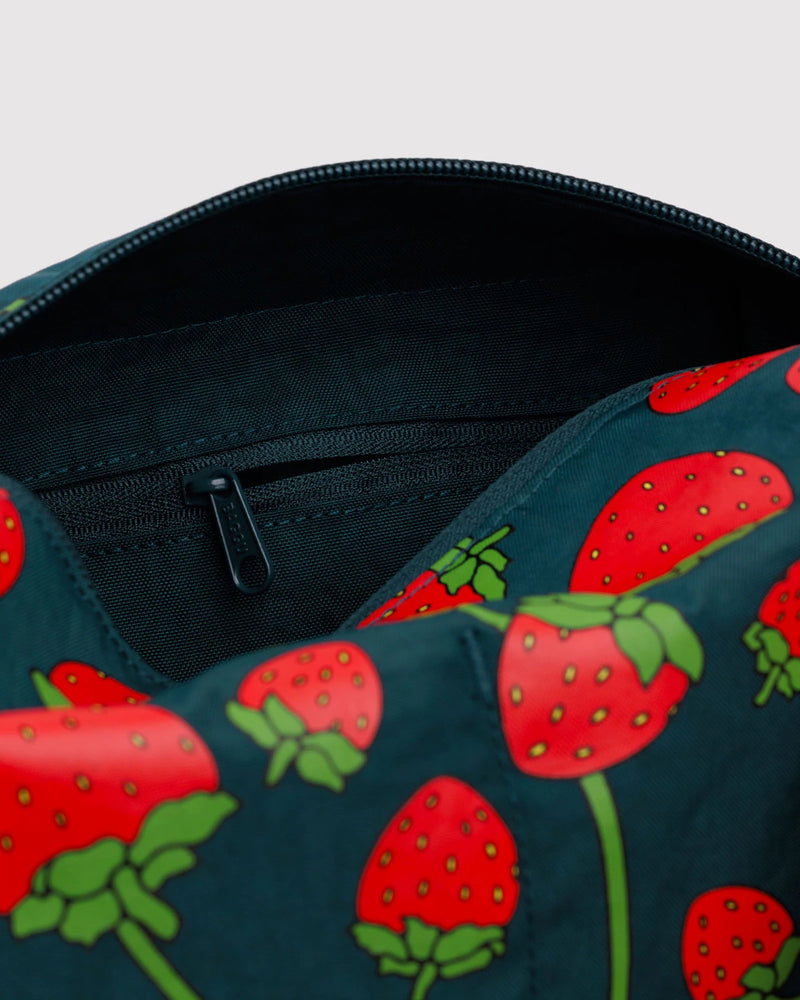 Close-up of a bag with red strawberry pattern on a dark blue background
