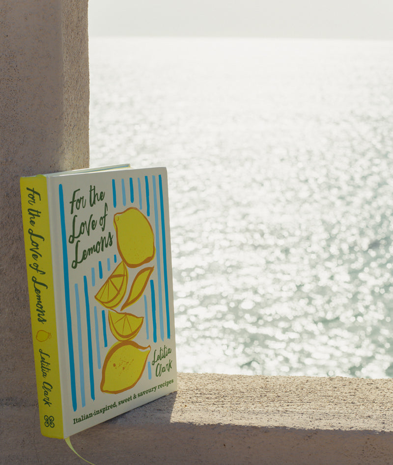 Book titled 'For the Love of Lemons' by Lillie Clark on a surface with a blurred background