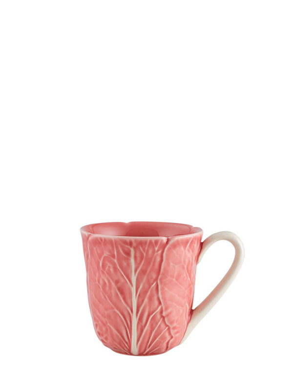 Pink mug with leaf pattern on a white background
