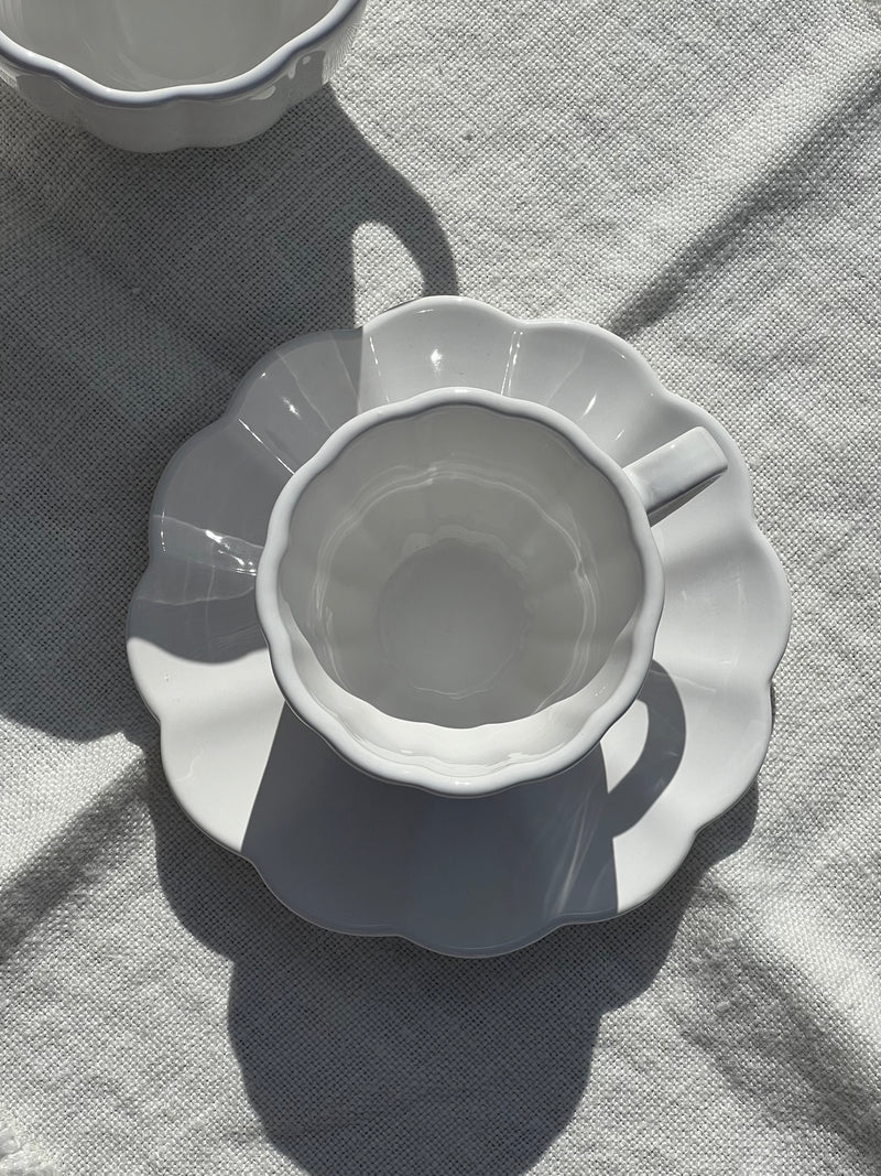 White ceramic pitcher on a textured surface