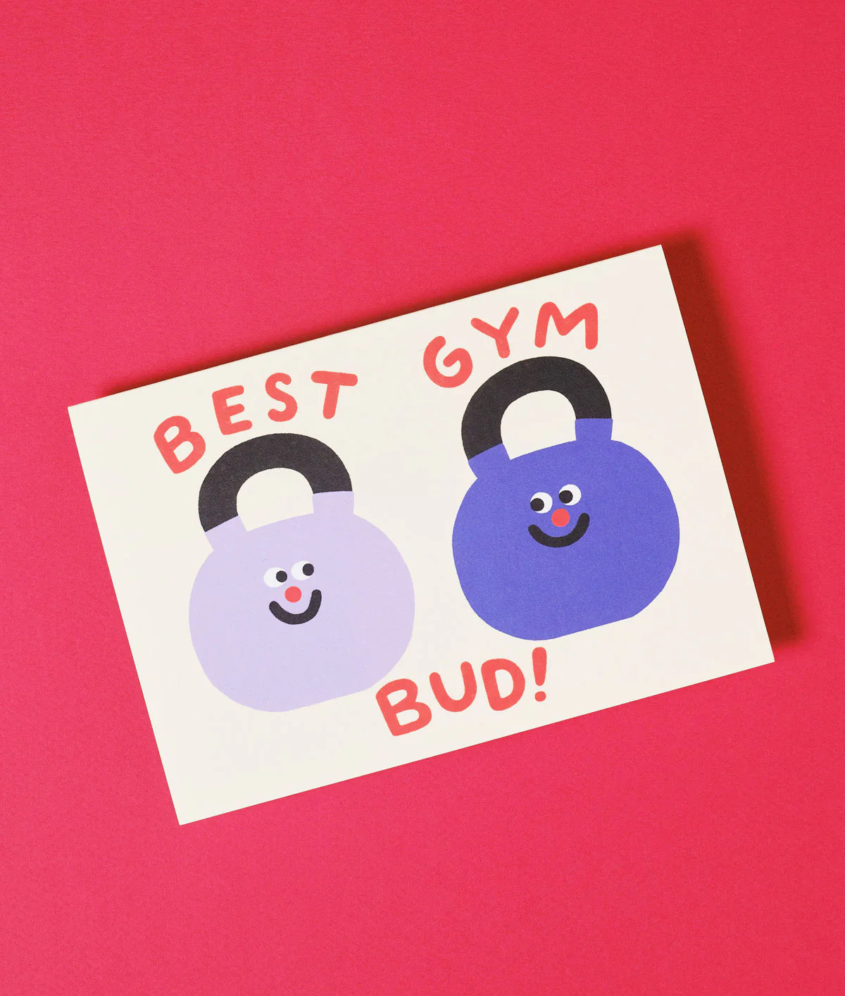 Card with two blue kettlebells and text 'BEST GYM BUD!' on a pink background