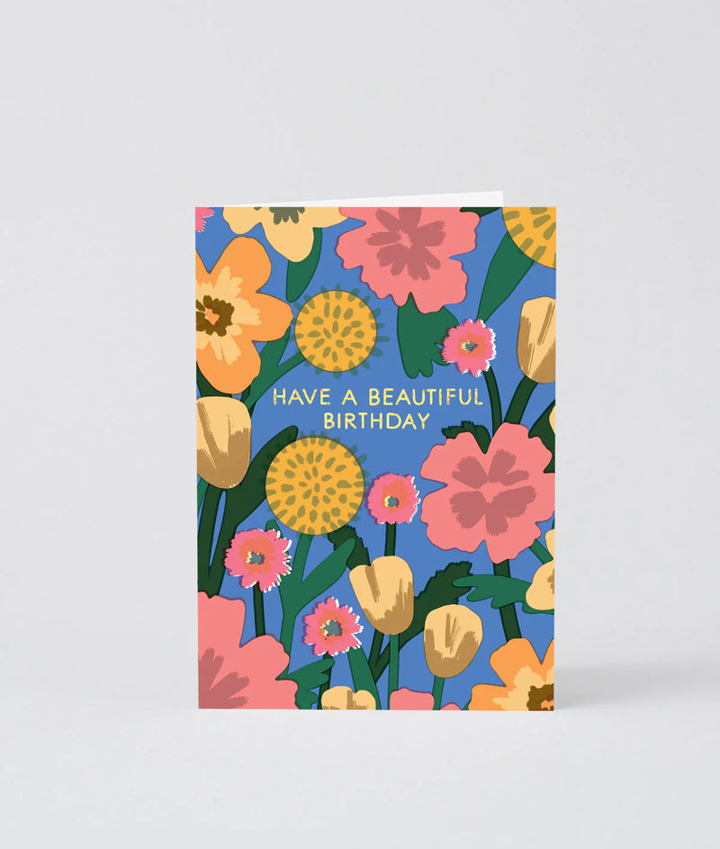 Greeting card with colorful floral design and 'Have a Beautiful Birthday' text on a blue background