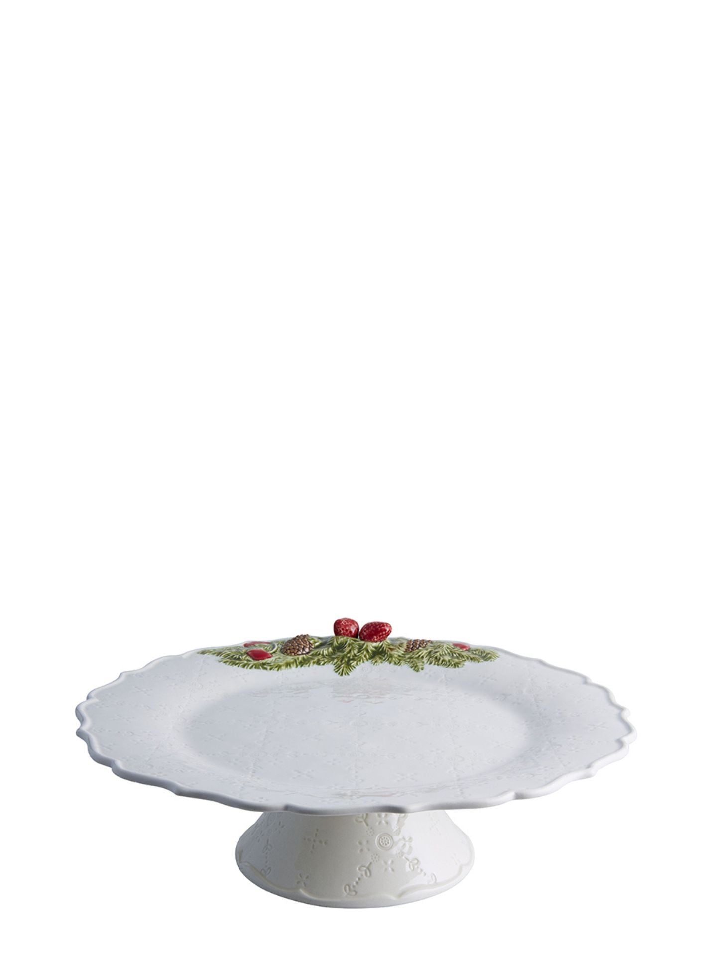 White ceramic cake stand with decorative elements on a white background