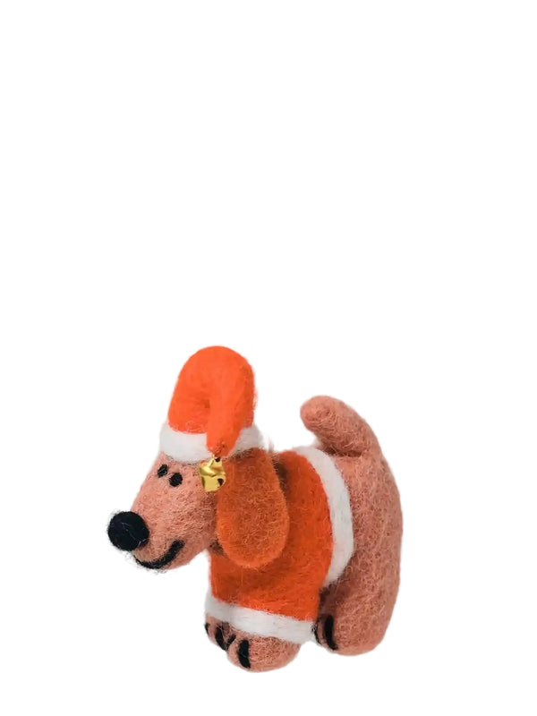 A felt Christmas ornament shaped like a dog wearing an orange Santa hat and matching orange and white sweater, hanging by a thin white string against a light gray background.