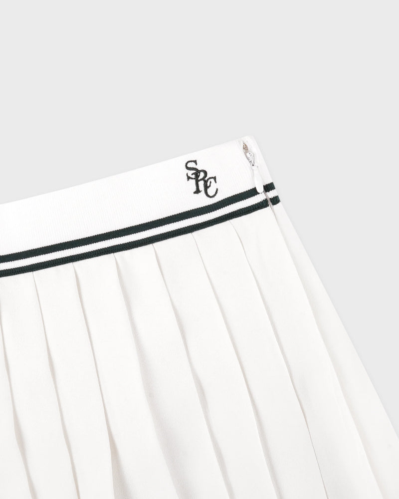 White pleated skirt with black trim and a logo on a light gray background