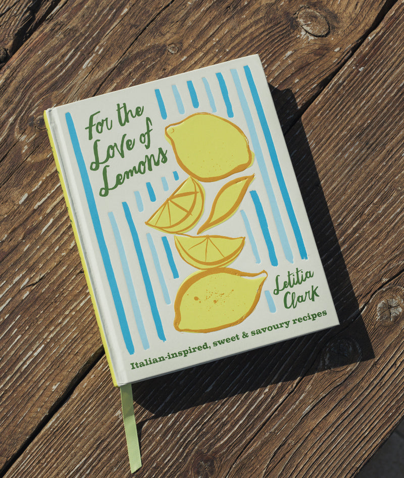 Book titled 'For the Love of Lemons' by Latitia Clark on a wooden surface