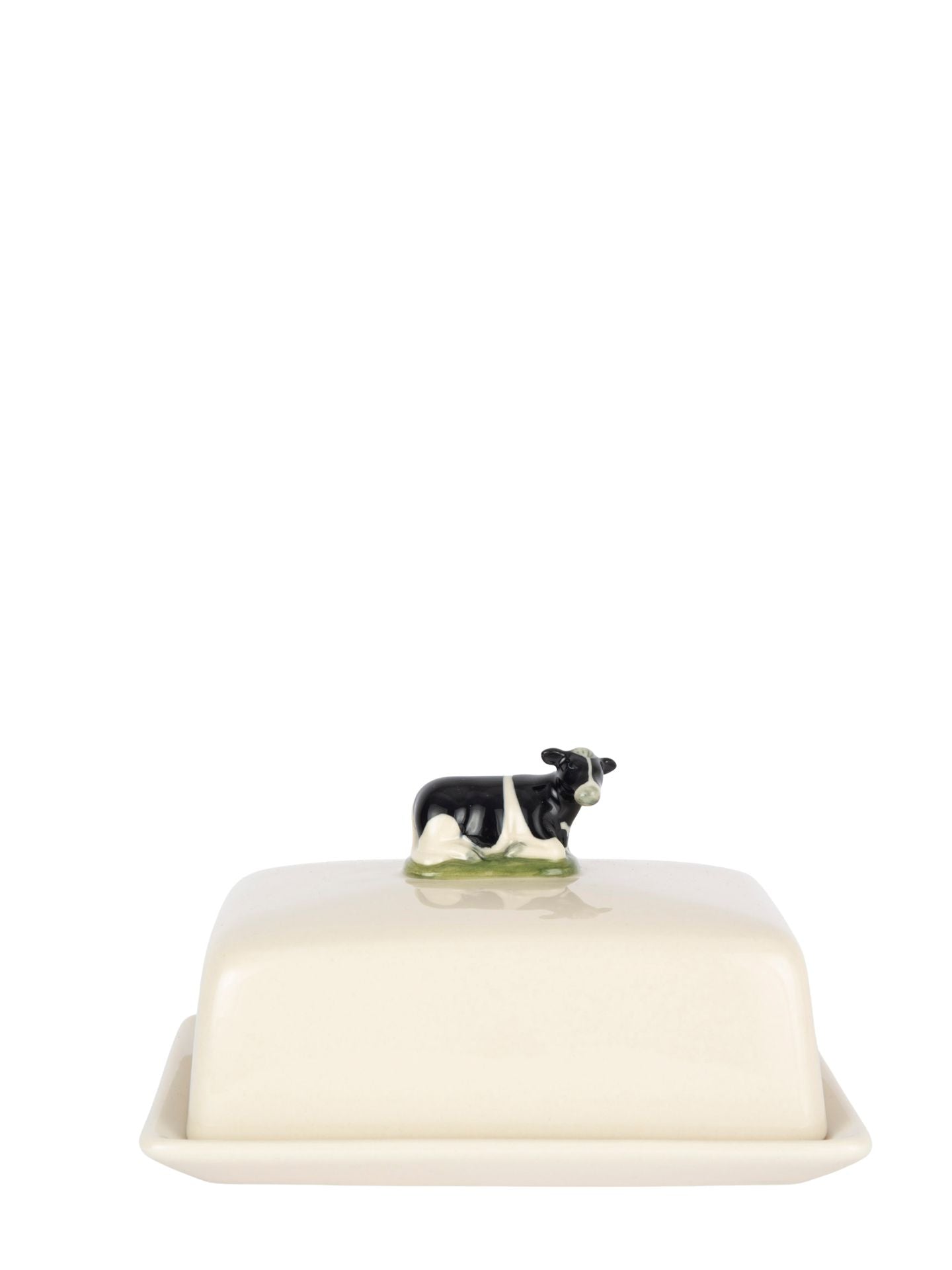 Cow on a white ceramic butter dish. 