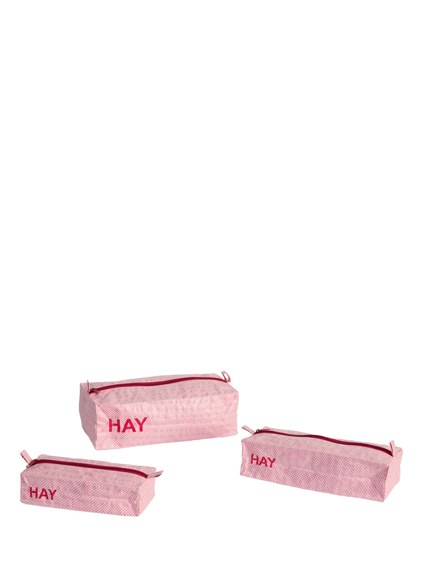 Three light pink patterned zippered pouches with red trim and the word 'HAY' printed in red on the front, arranged on a plain white background.