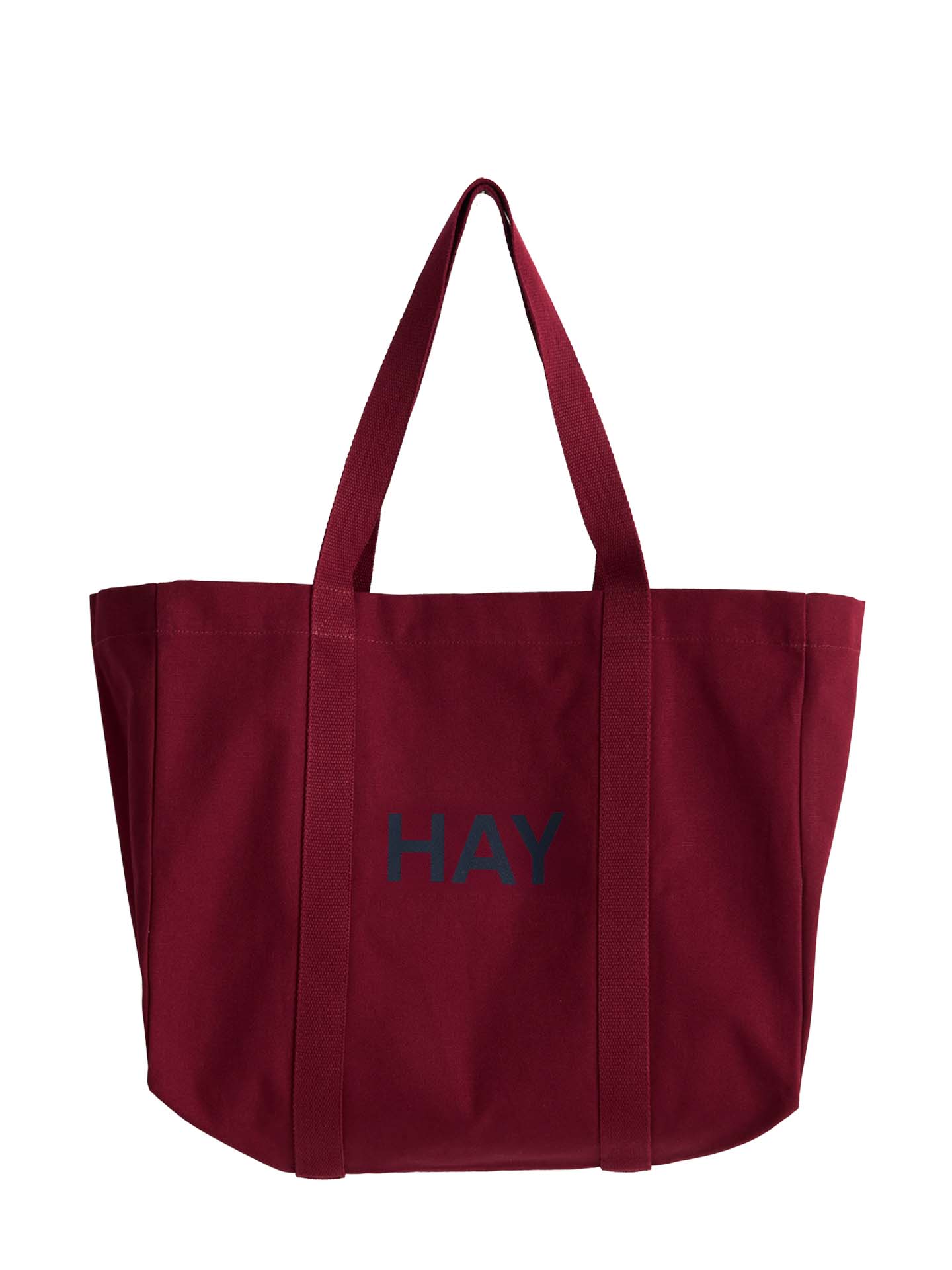 A dark red canvas tote bag with the word 'HAY' printed in dark navy on the front, set against a plain white background.
