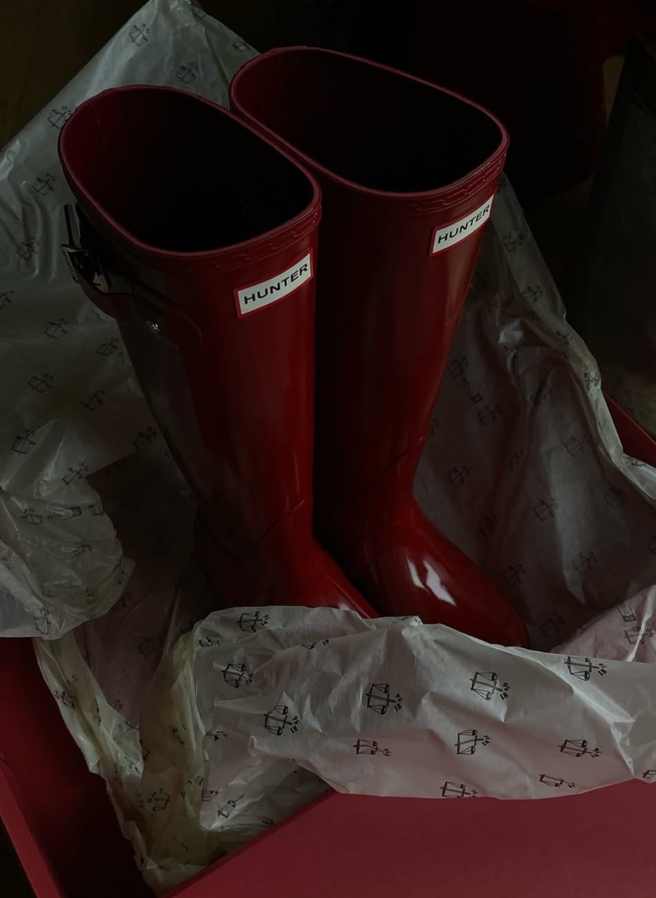 Red Hunter boots in a box with tissue paper.
