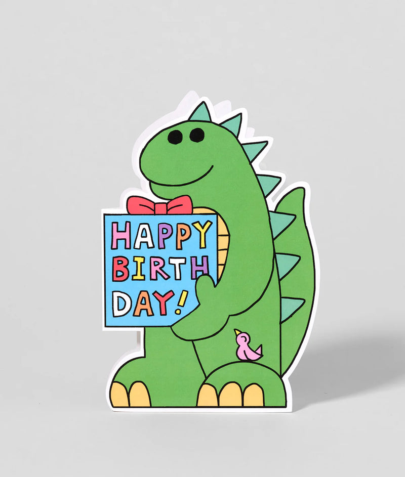 Green dinosaur with a 'Happy Birthday!' sign on a gray background