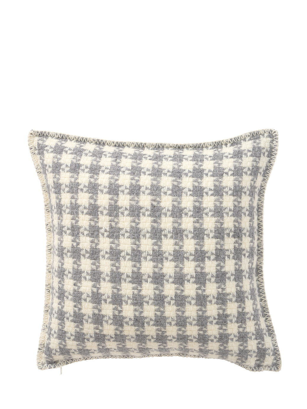 Dogtooth patterned cushion on a white background