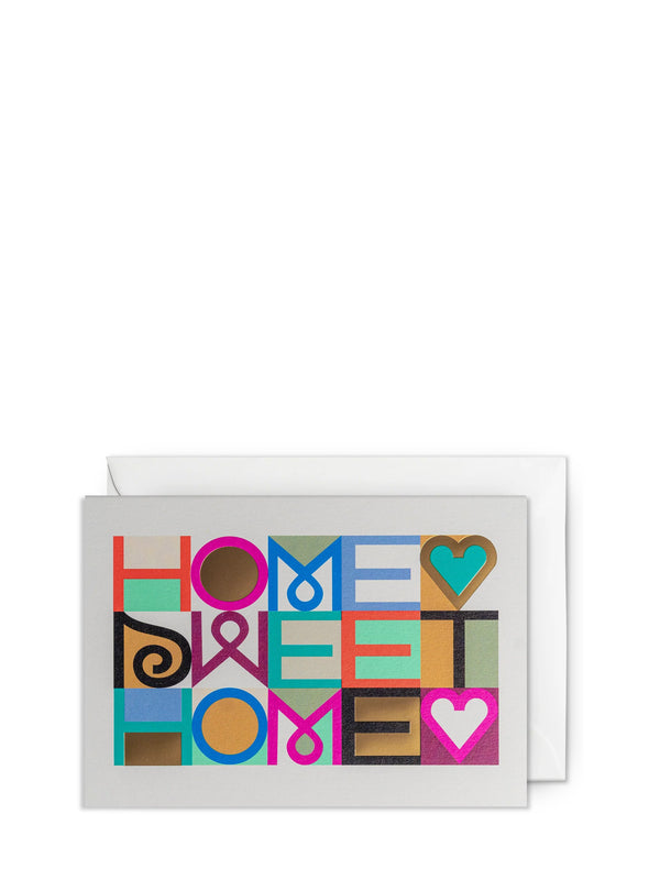Greeting card with 'Home Sweet Home' text in colorful block letters on a white background