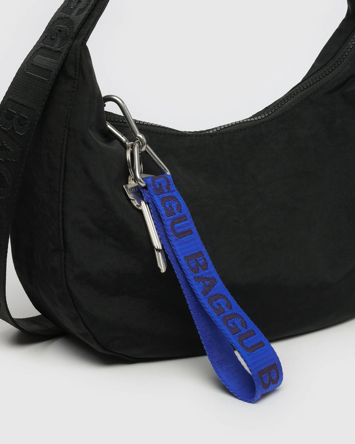Black bag with a blue strap featuring 'BAGGU' branding on a white background