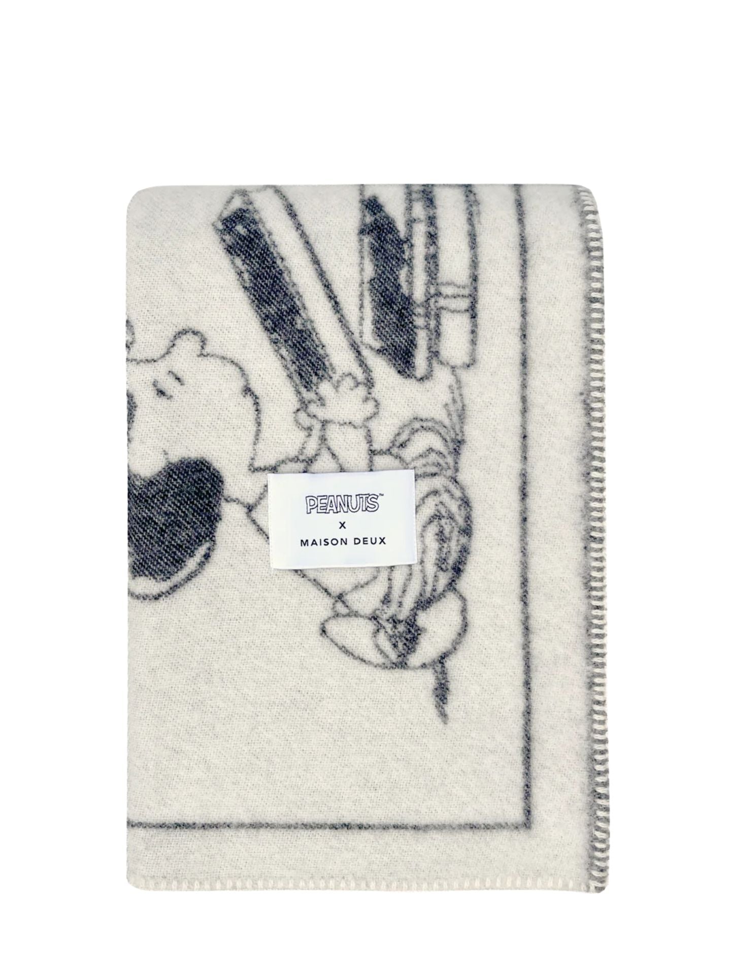 Blanket with Peanuts cartoon design and 'Folie' label on a white background