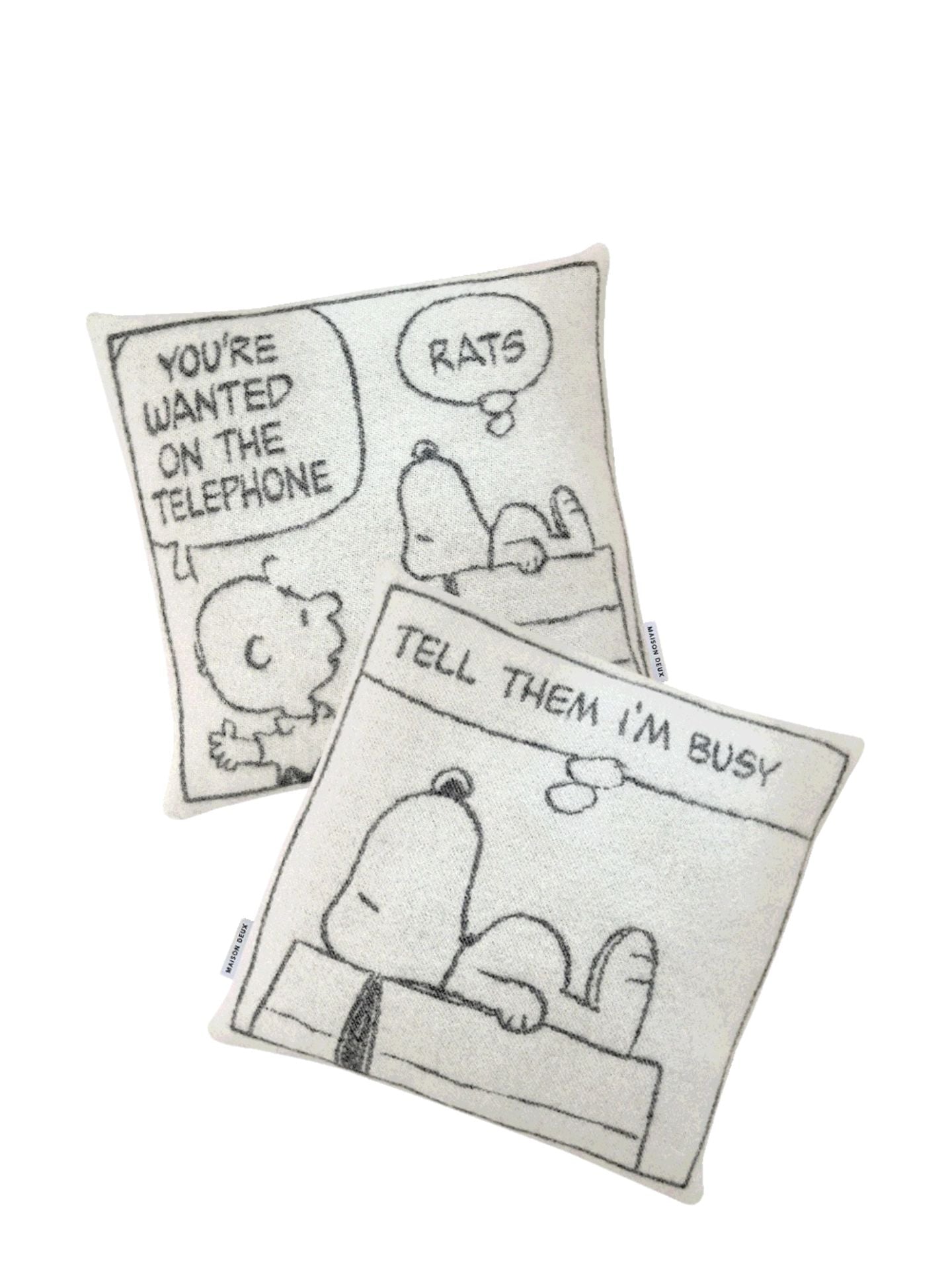 Two black and white pillows with cartoon designs on a white background