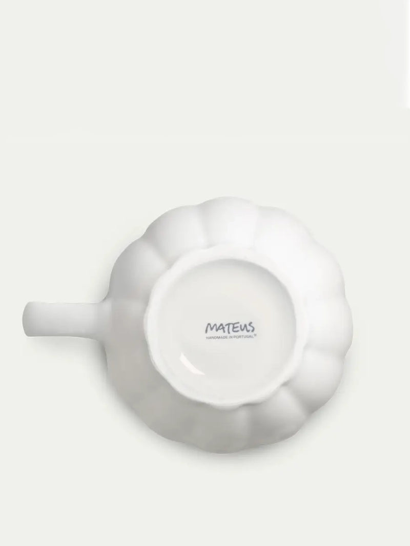 White ceramic mug by Mateus on a light gray background