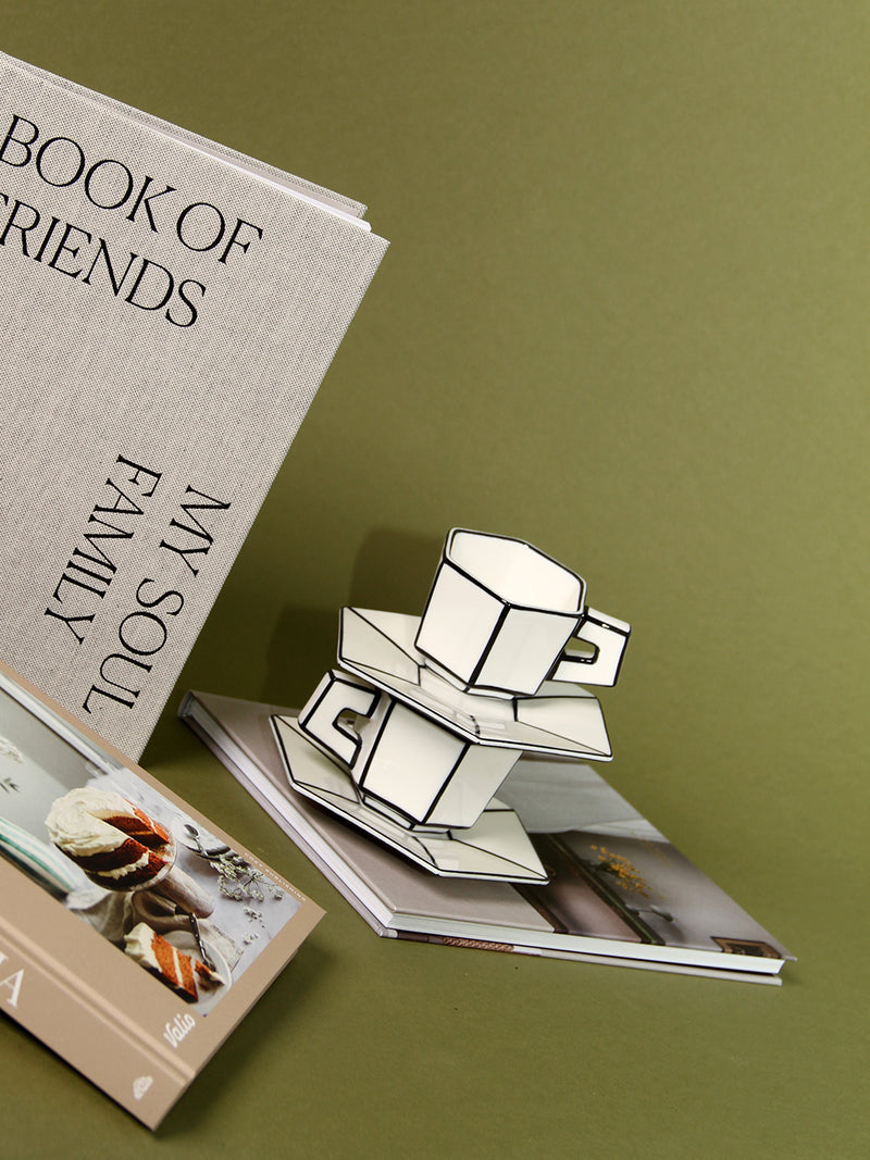 Stack of books with espresso cups