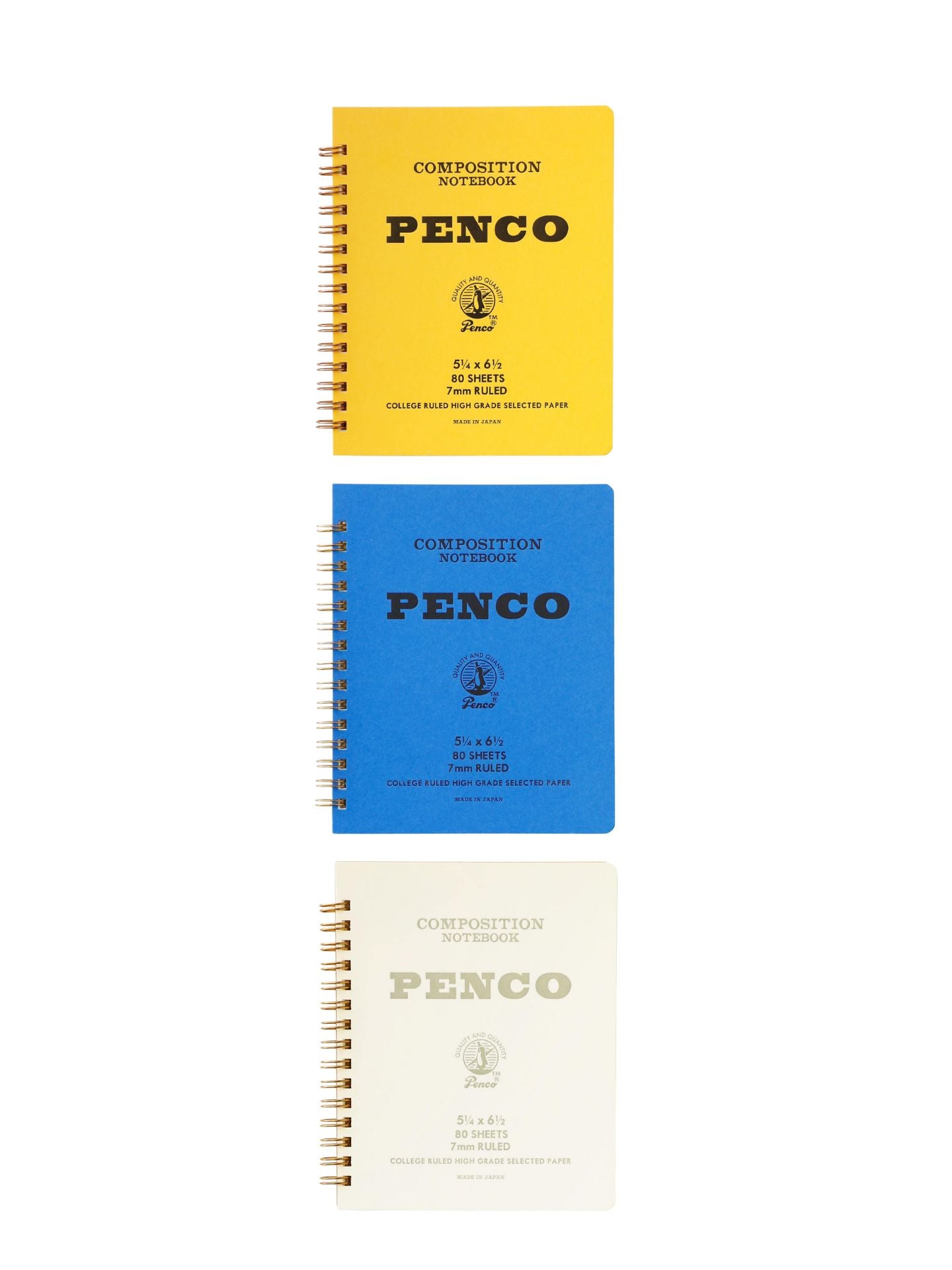 Three Penco composition notebooks in yellow, blue, and white on a white background