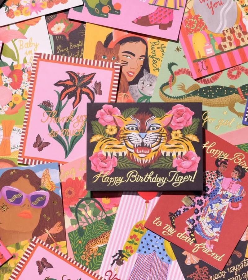 Collection of colorful greeting cards with various designs and text.