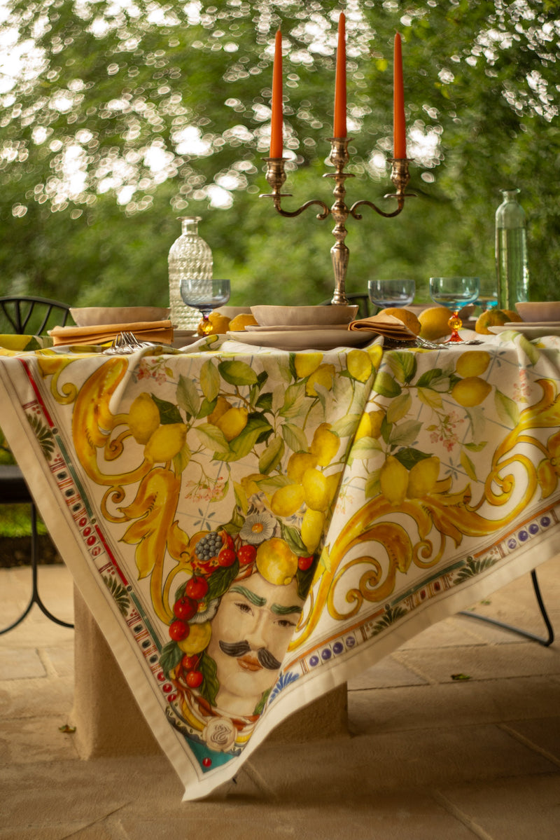Decorative tablecloth with artistic design on a table outdoors.
