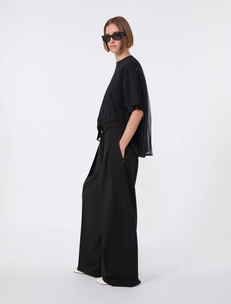 Person wearing a black outfit on a white background