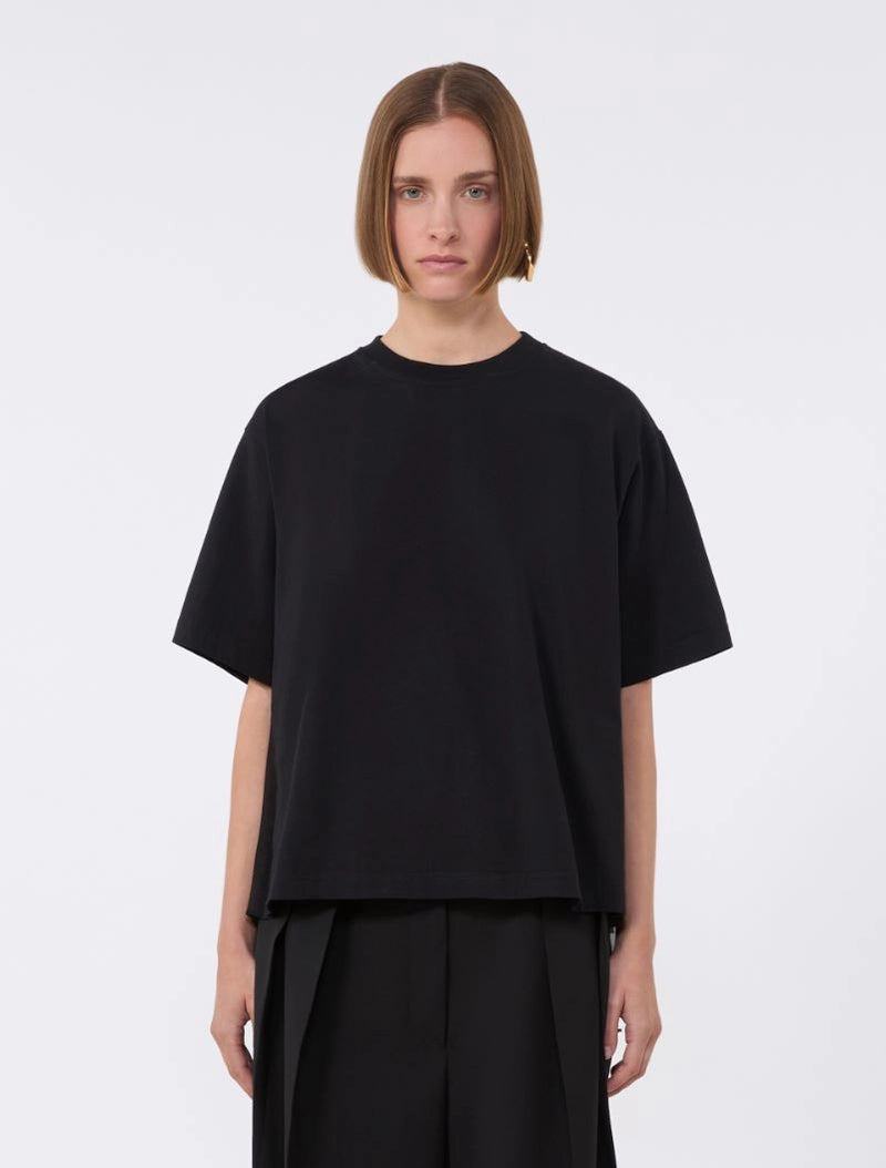 Person wearing a black oversized t-shirt and pants on a white background