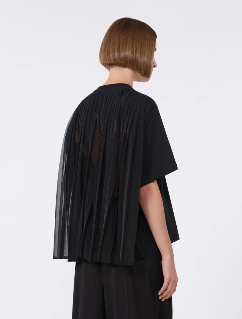 Person wearing a black outfit with sheer panels on a white background
