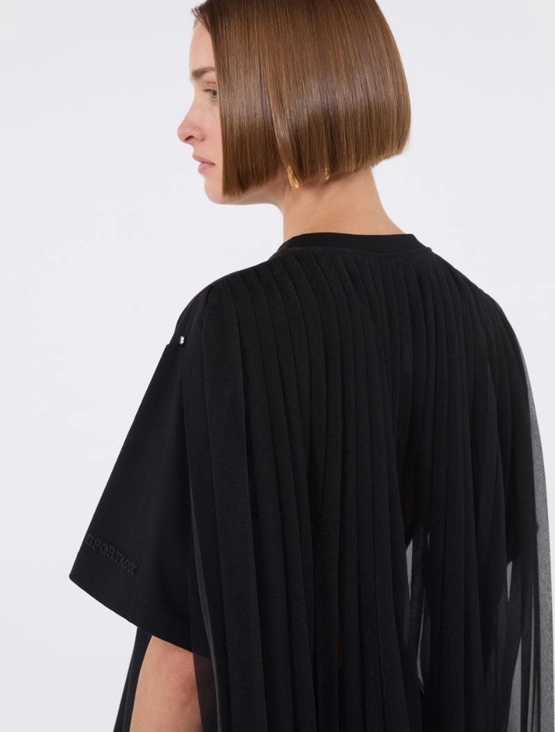Person wearing a black outfit with a plain background