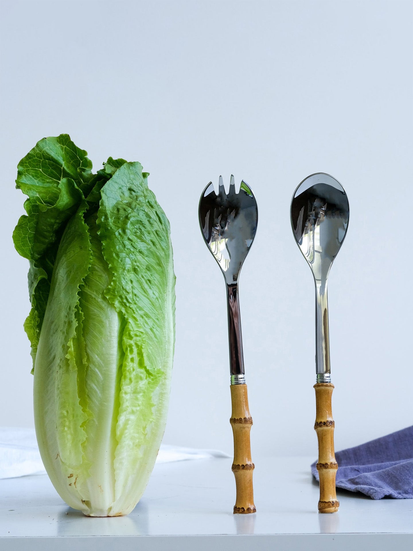 Salad servers next to cabbage