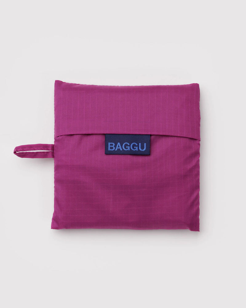 Purple reusable bag with 'BAGGU' logo on a light gray background