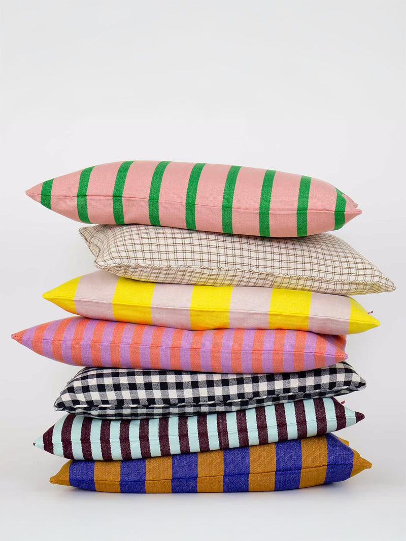 Stack of colorful striped pillows on a white background