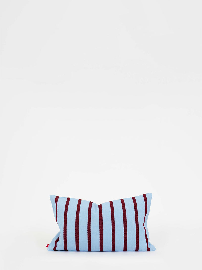 Striped pillow with red and blue pattern on a white background