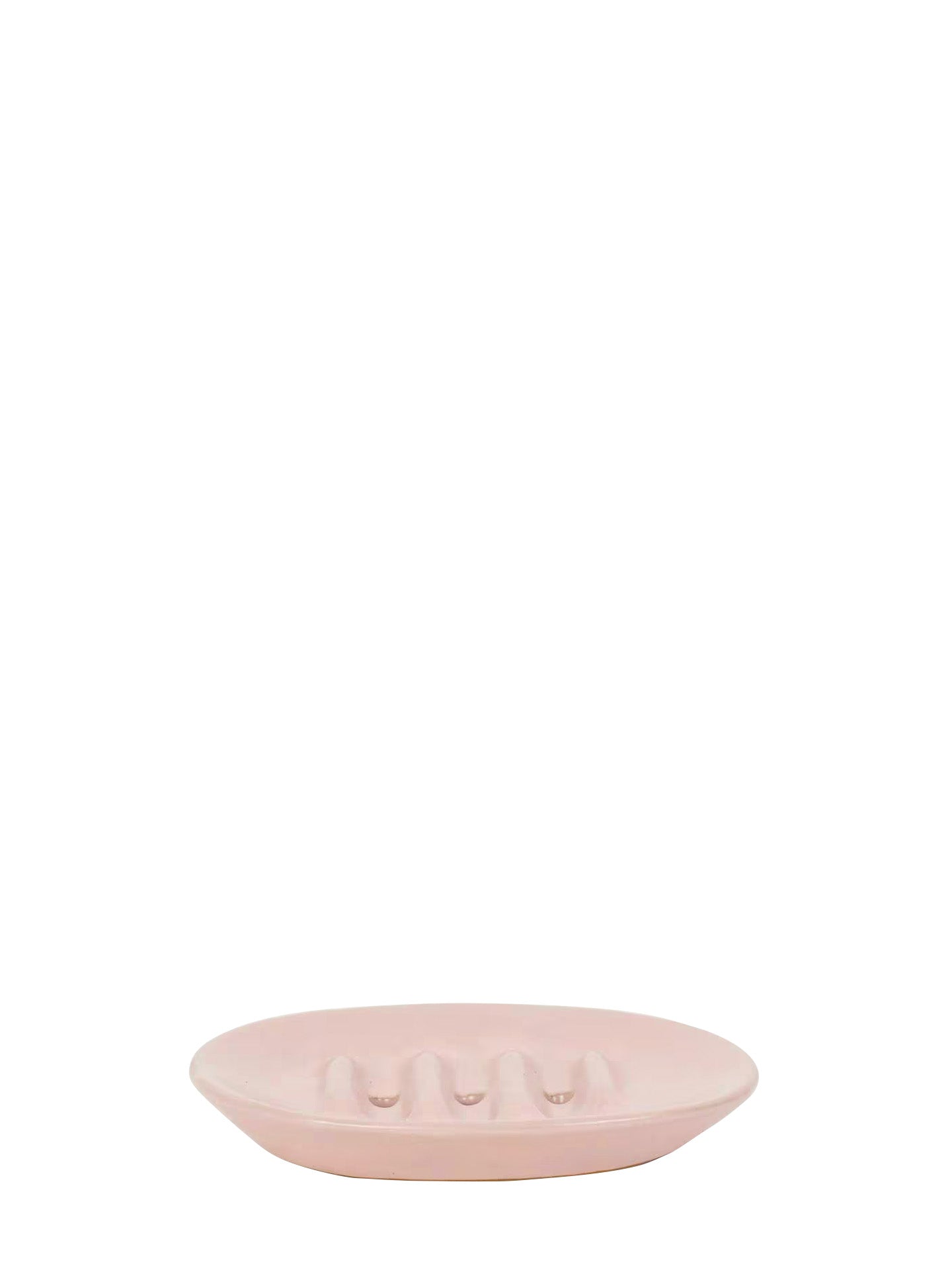A light pink oval ceramic dish with a textured, ribbed surface and three holes at the center for a soap bar, shown against a solid white background.