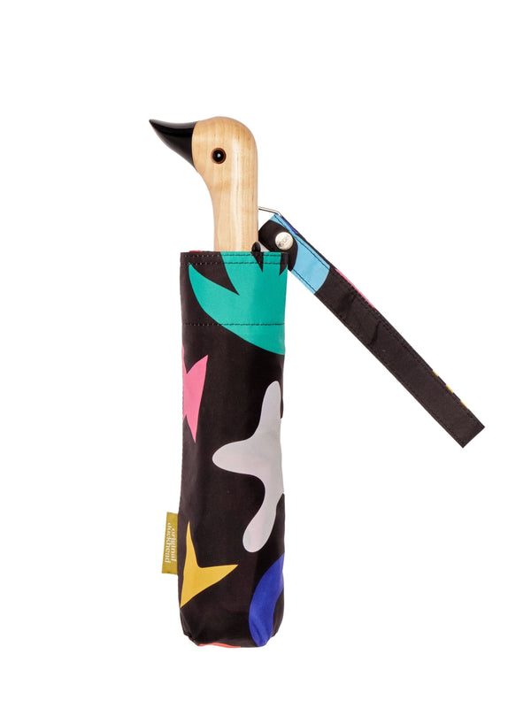 Colorful umbrella with abstract design and wooden handle on a white background