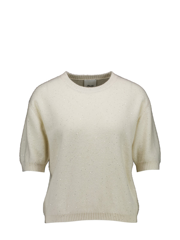 Lightly fitted off-white knit sweater with short sleeves and subtle glittery speckles, displayed against a solid white background.